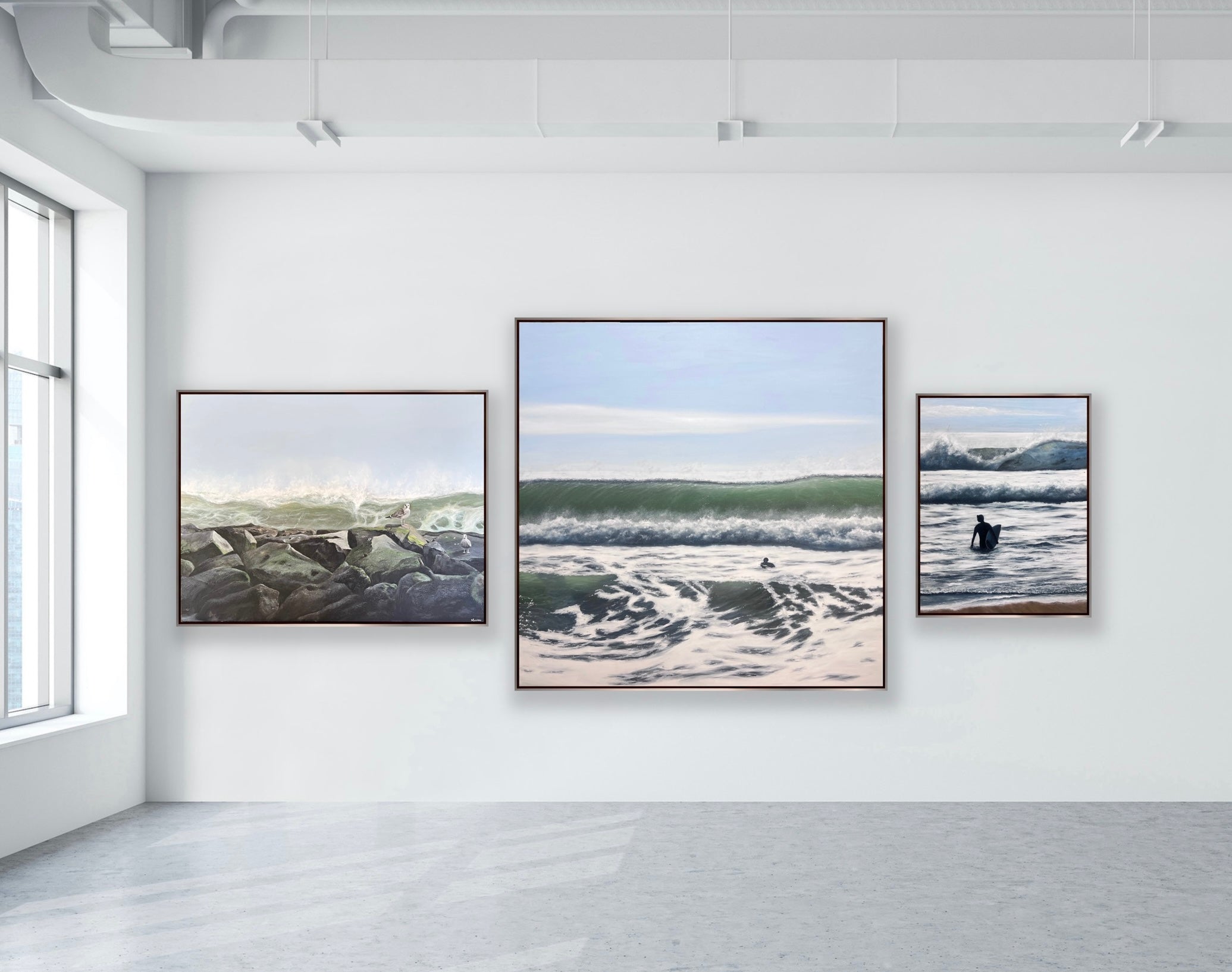 Three framed artworks depicting natural landscapes on a white wall.