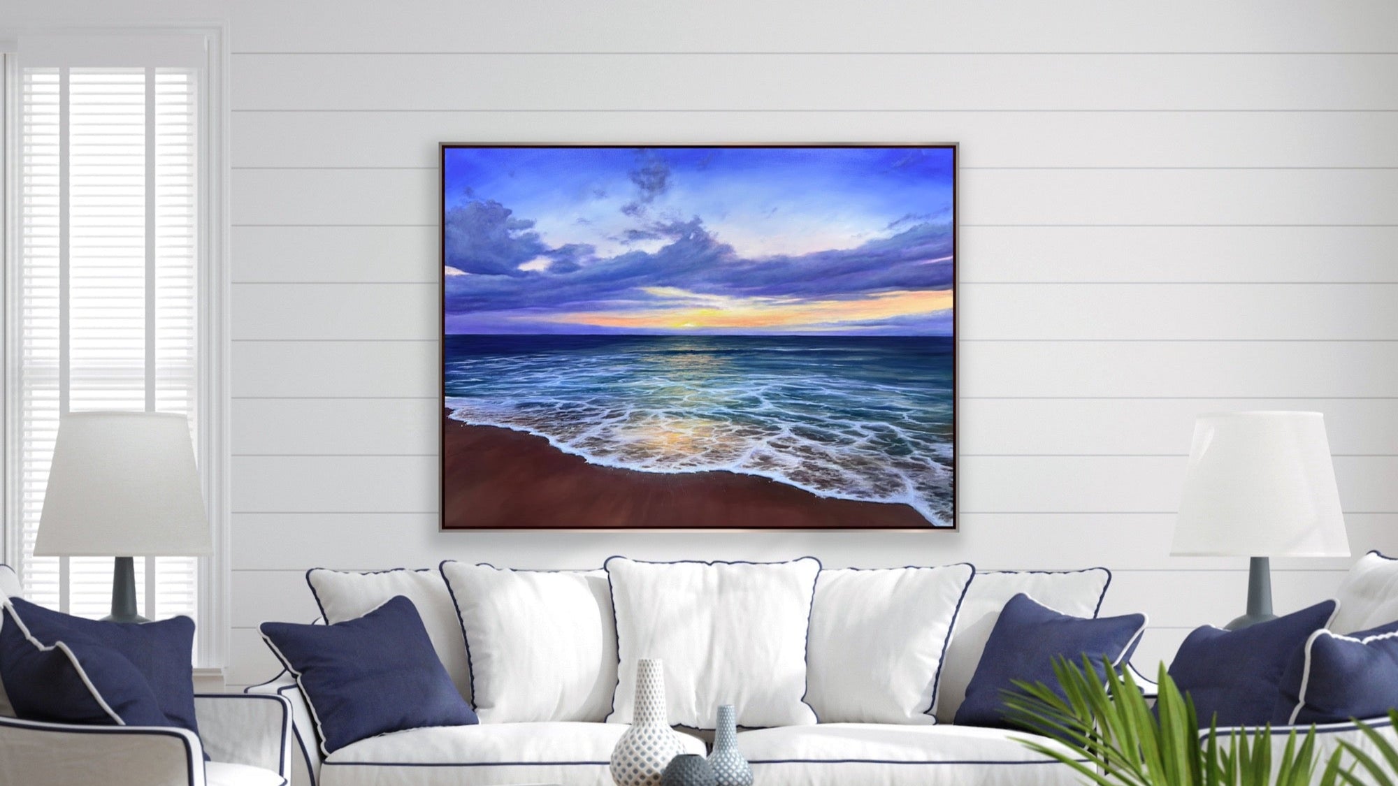Living room with a white sofa, wooden coffee table, and a large TV displaying a beach scene.